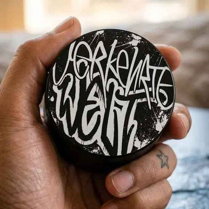 Yerkenate wax container held in hand, featuring bold black and white graffiti-style lettering.