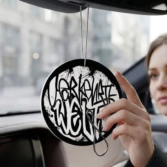 Car Air Freshener with unique black and white design, hanging from rearview mirror.