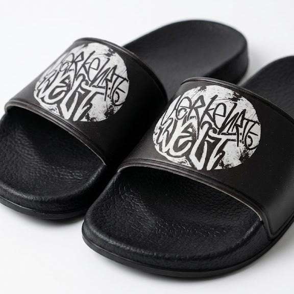 Graphic slide sandals featuring bold black and white design for casual wear.