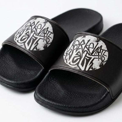 Graphic slide sandals featuring bold black and white design for casual wear.