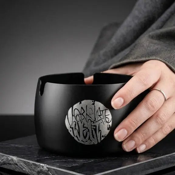 Handcrafted black ceramic bowl with intricate silver design, perfect for modern decor.