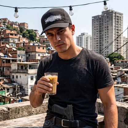 Black baseball cap featuring a unique design, worn by a man holding a drink in an urban setting.